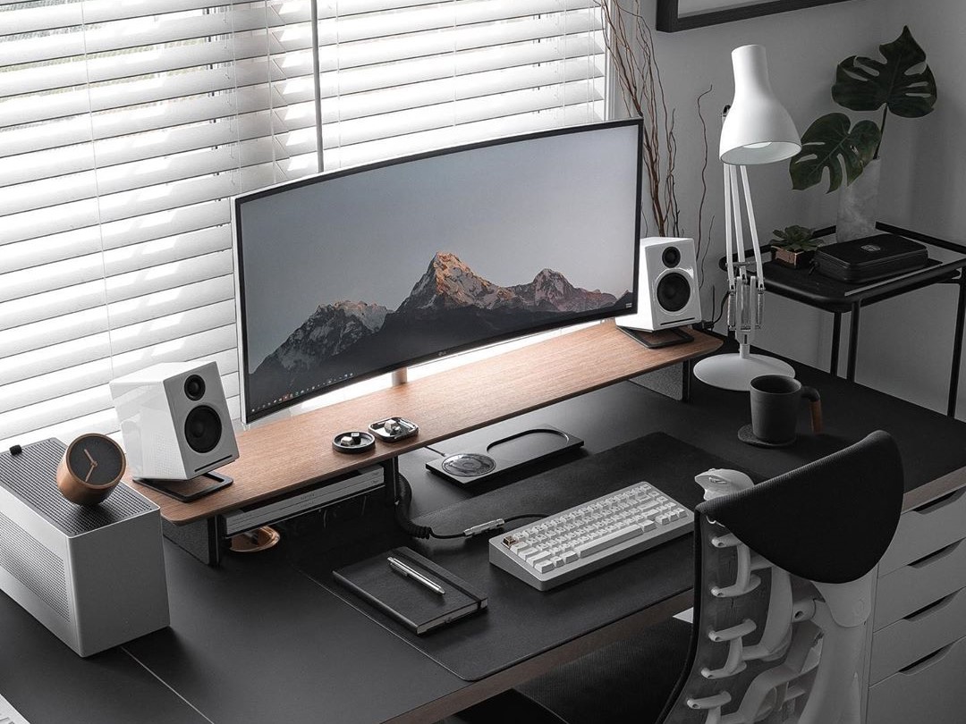 Minimalist computer setup with laptop, monitor, and accessories